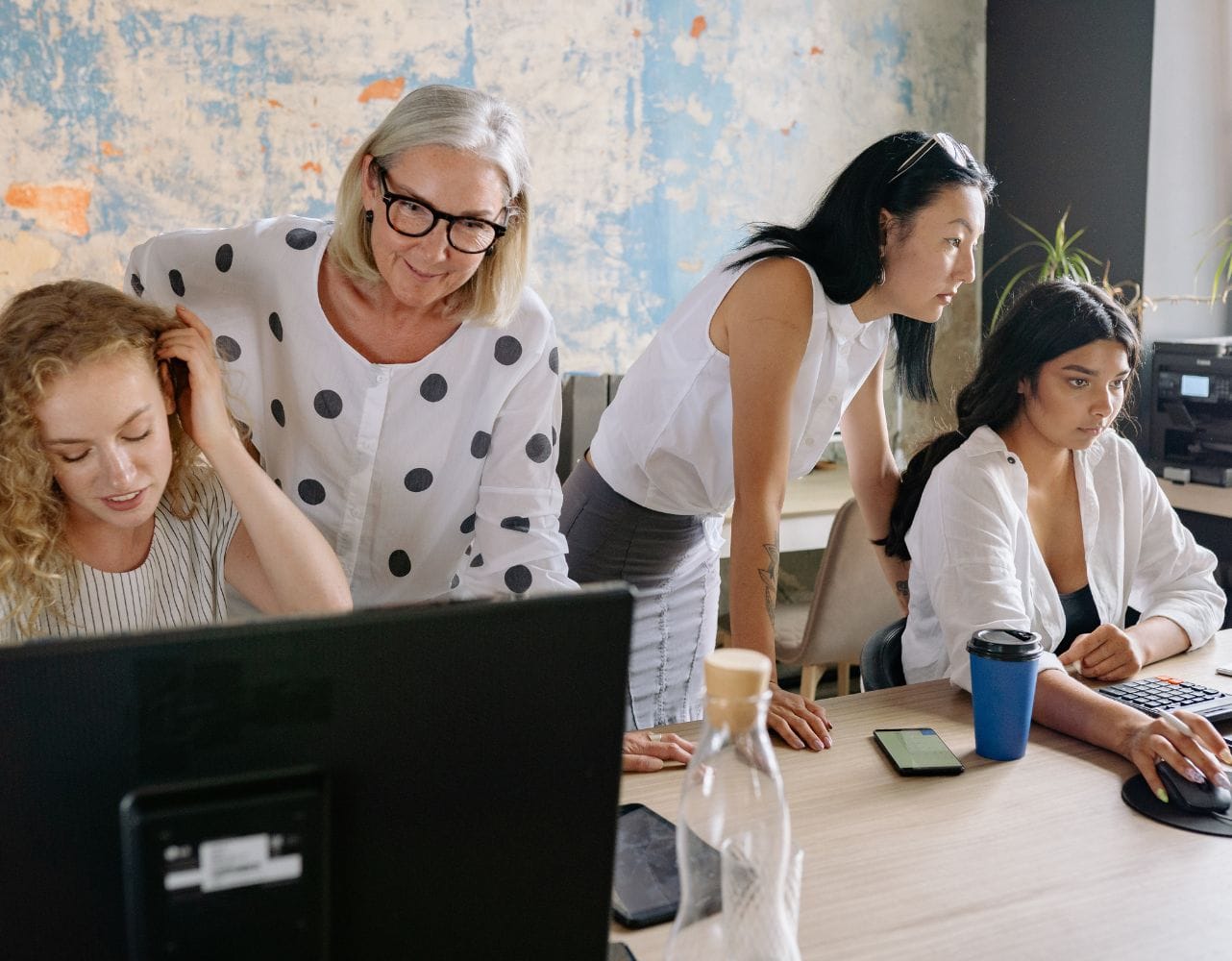 Multigenerational teams collaborate to complete a shared project successfully