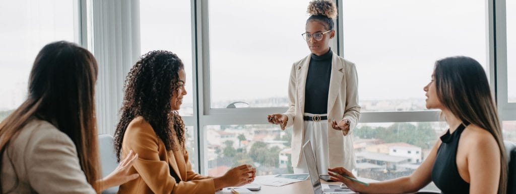 senior leader discussing the benefits of leadership development with executives during a meeting