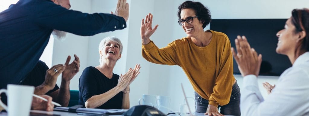team members collaborating and smiling during an interactive workshop