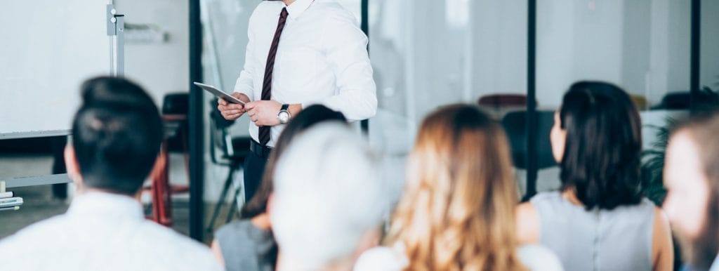 Business leader listening to team feedback during a collaborative staff meeting