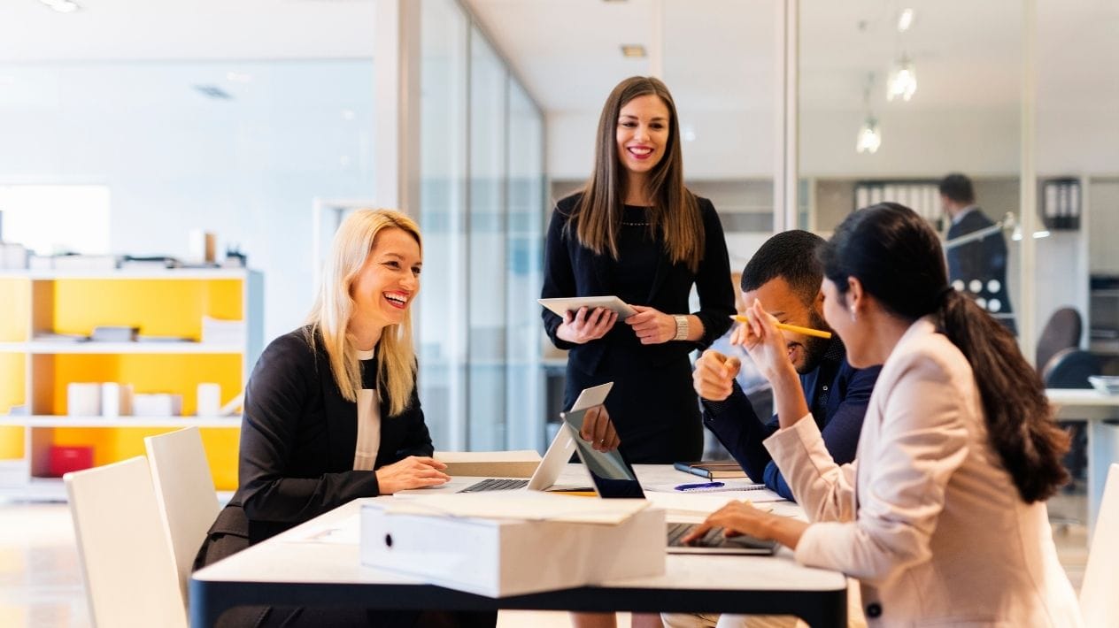 Employees review ideas to support workplace wellbeing during a team meeting